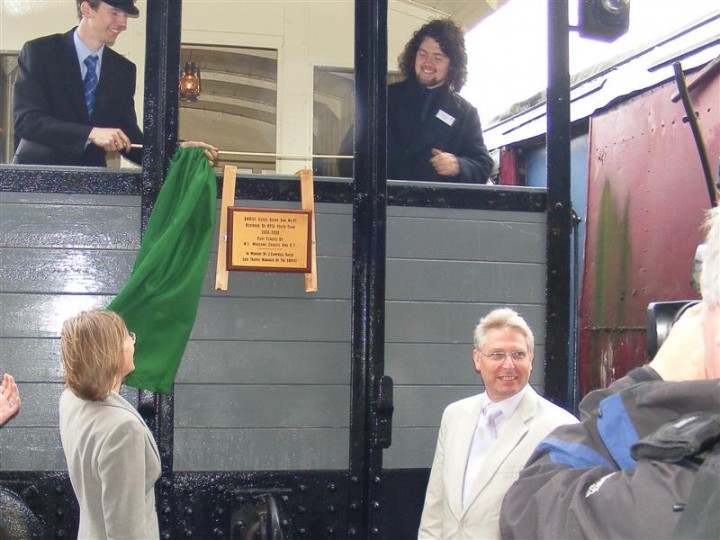 The plaque on IVAN being unveiled, 30th July 2008. In the van are James and Ben, who both worked on the project. Tugging at the flag/curtain is Catherine Mason. Mark Cosgrove, deputy Mayor of Carrickfergus, applauds the unveiling while Sandy Smith of the International Fund for Ireland looks on in approval.