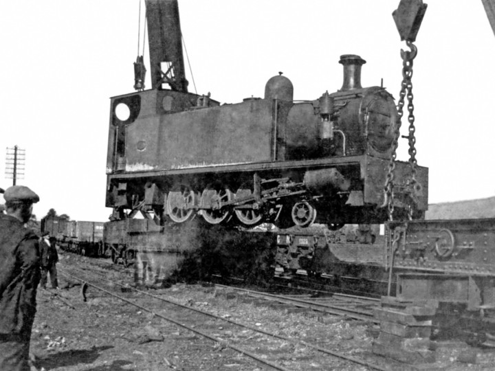 October 1934: Both cranes unload Castlederg No.4 at Maguiresbridge.