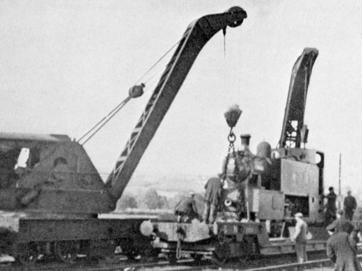 October 1934: Both cranes unload Castlederg No.4 at Maguiresbridge.