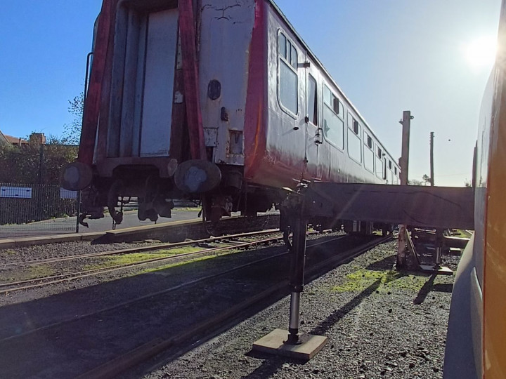 3/11/2022: The Larne end of the coach is lifted by a lorry crane for a bogie swap. (D. Mackie)