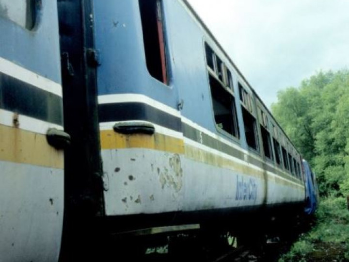 14/5/2007: The derelict Mk2b Open Standard on accommodation bogies at the back of the Whitehead yard. (N. Knowlden)