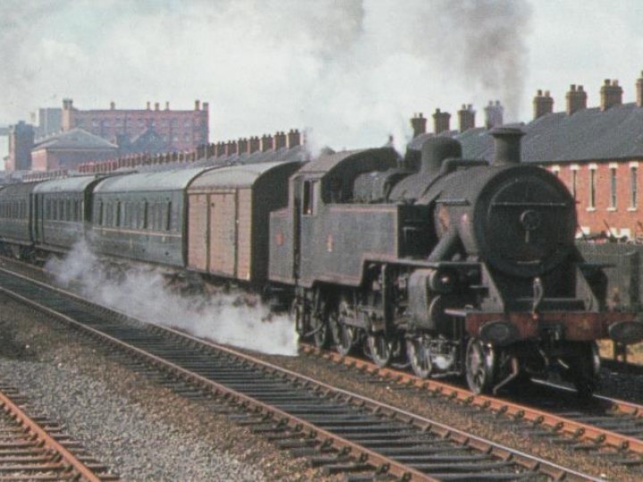 2/7/1966: A classic NCC scene! No.4 and train, with a brown van in front, accelerates away from Belfast York Road with a Sunday School special for Portrush. (D.Young)