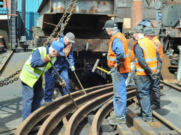 5/5/2016: The Site gang chipping rust off the turntable carrying rails. (C.P. Friel)