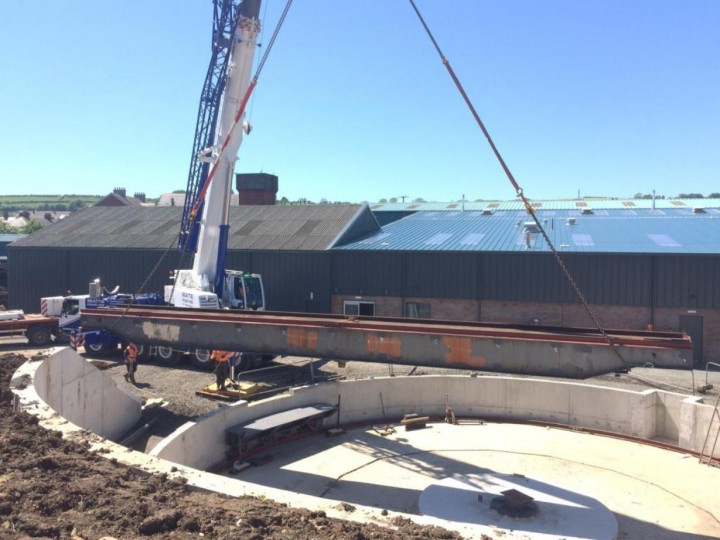 1/6/2016: The table installation was in two steps. First the crane lifted it from the yard to beside the pit. The crane then repositioned itself and lowered the table into the pit.  One of the refurbished turntable runners is plainly visible on the circular bearing rail. (A. Maxwell)