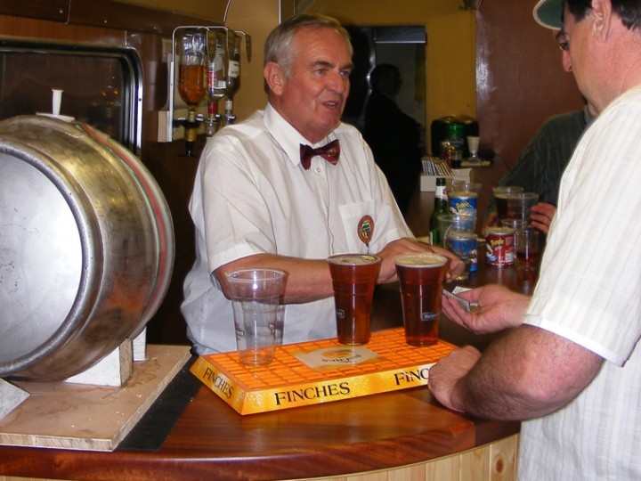 Peter Marsden serving passengers from behind the long bar on 547's first outing