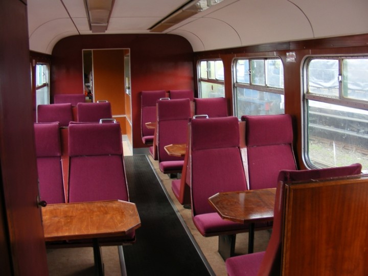 547's refurbished interior boasts varnished tables and maroon upholstered seating, before the curtains were hung