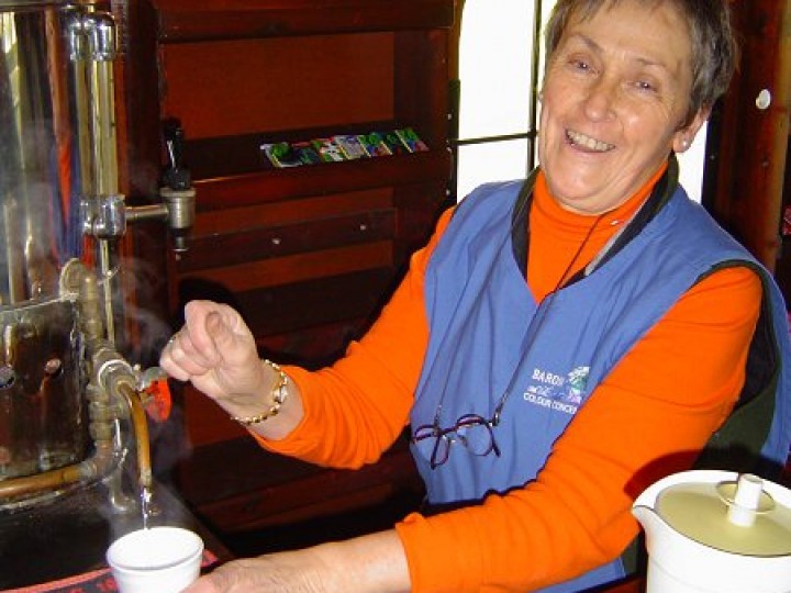 In the tea bar on 87's last trip on the main line, Rita Henderson prepares another cup of coffee. While in the bar, another pint is pulled for a passenger. Rita and the rest of the dining car staff had to wait 4 years before we had a steel bodied dining car ready (547) to take 87's place on our steam trains.