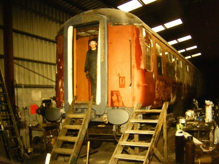 Alan McRobert, working on the gangway rubbers, peers out from 547's vestibule